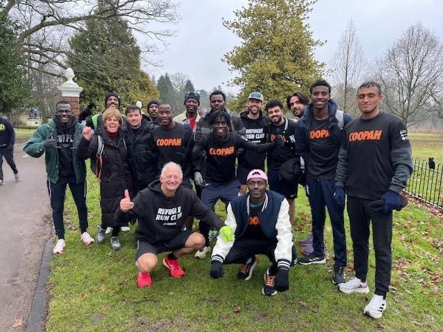 Refugee Run Club members together in the park, in club tops
