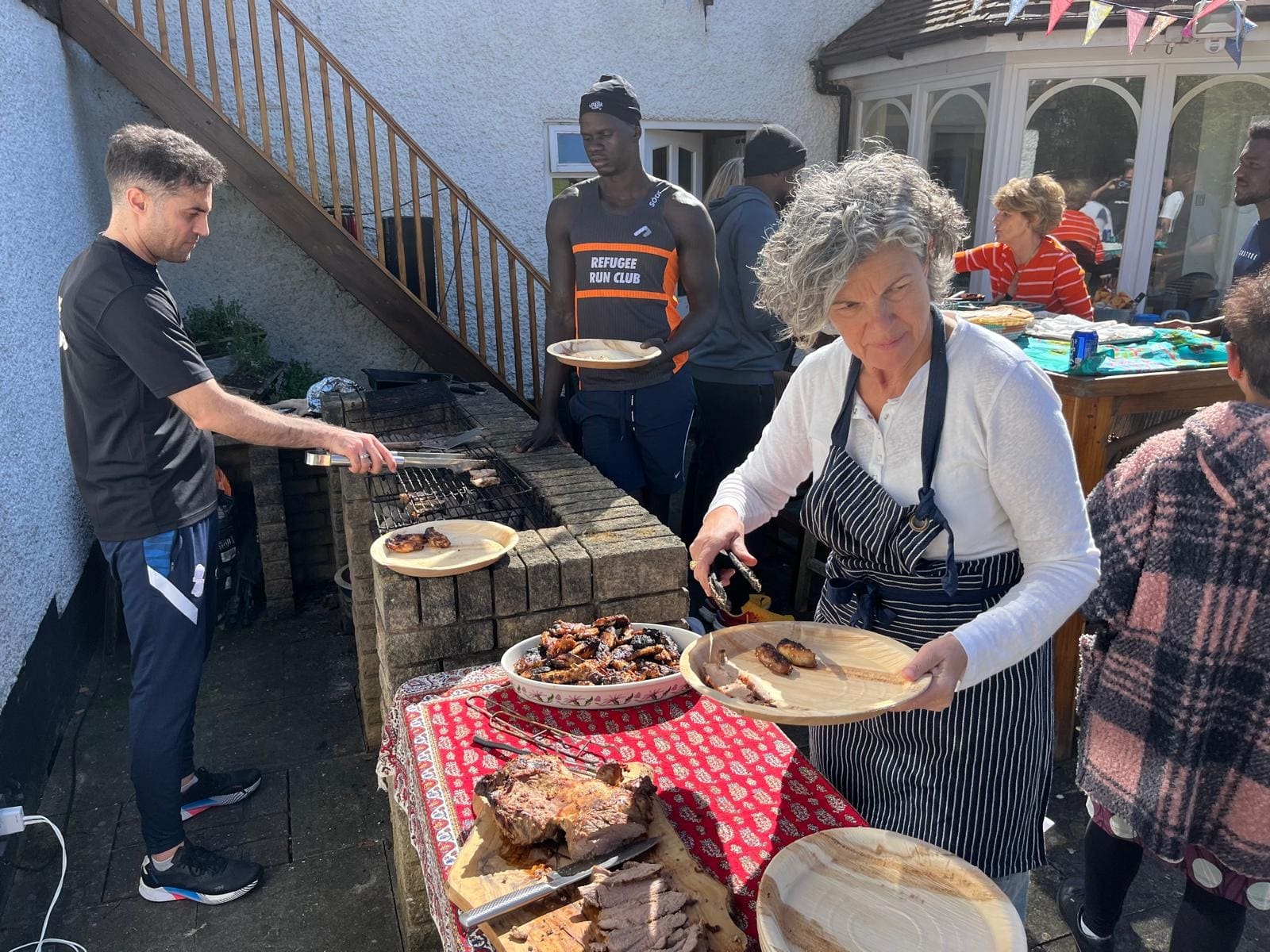 Serving food from the barbecue in the garden