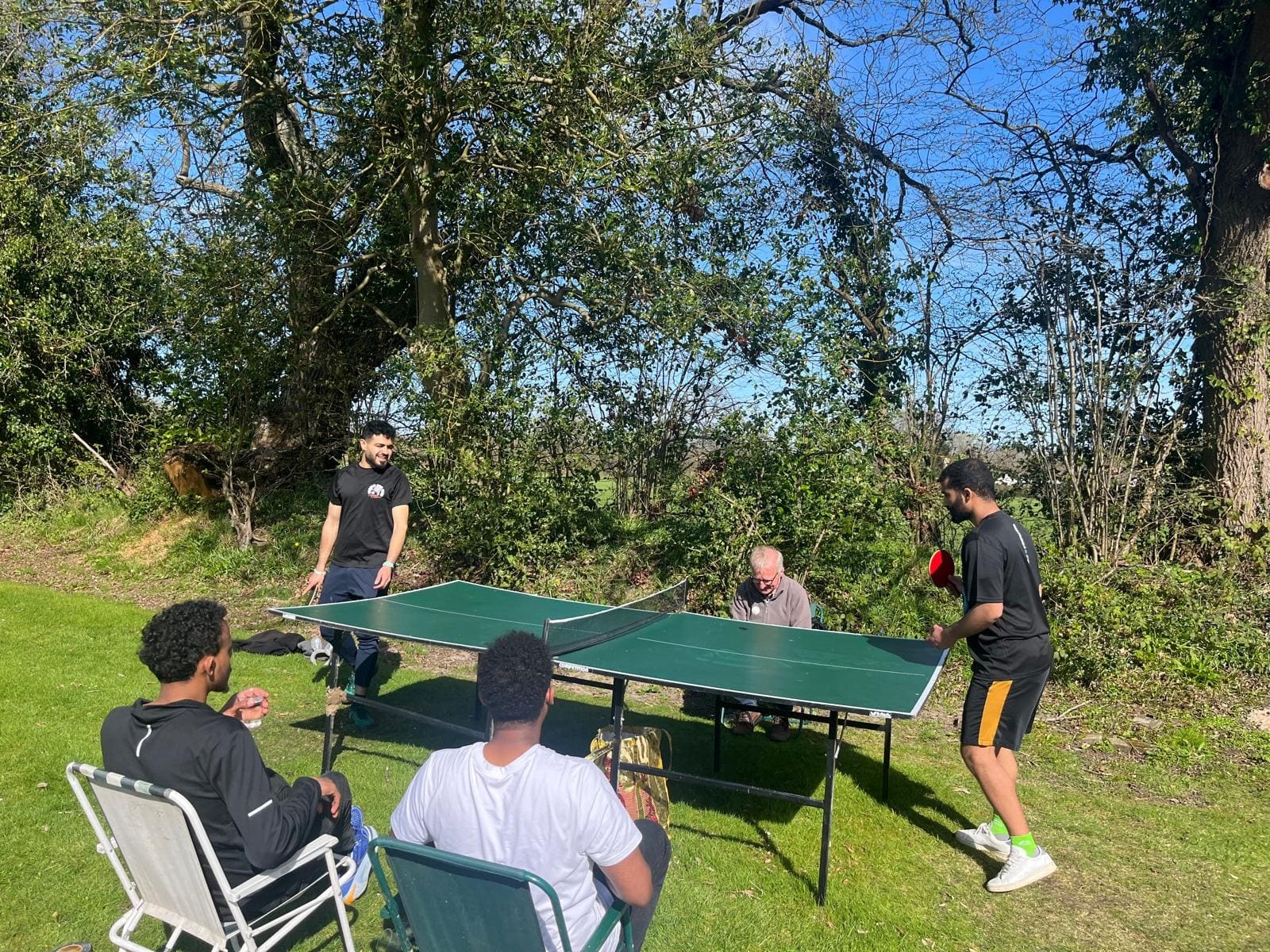 A game of table tennis on the lawn