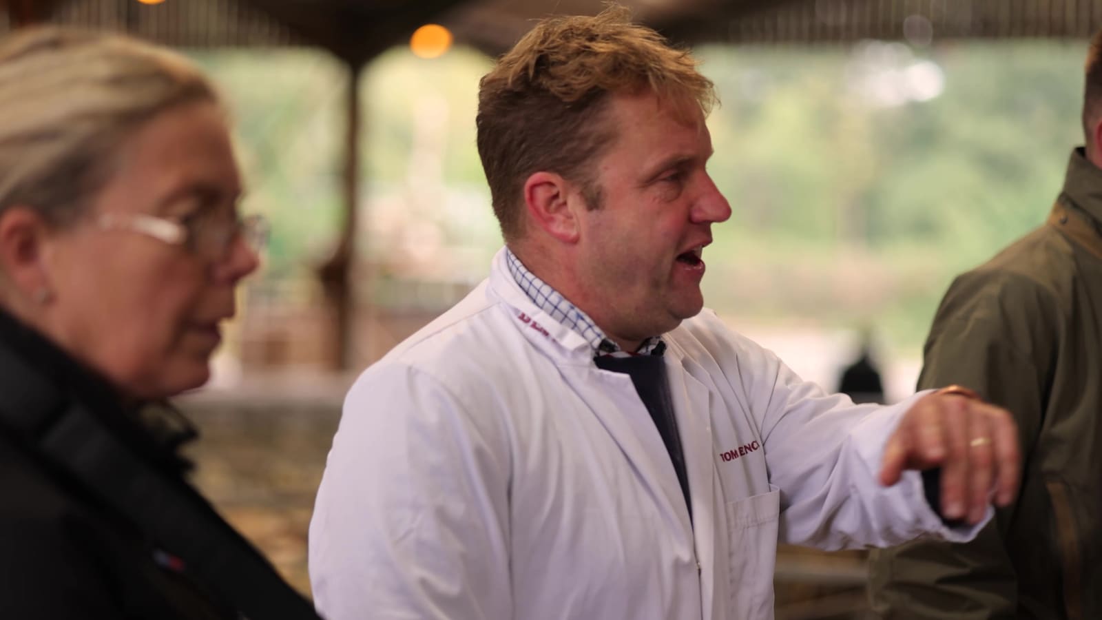 The auctioneer talking with a buyer at the mart